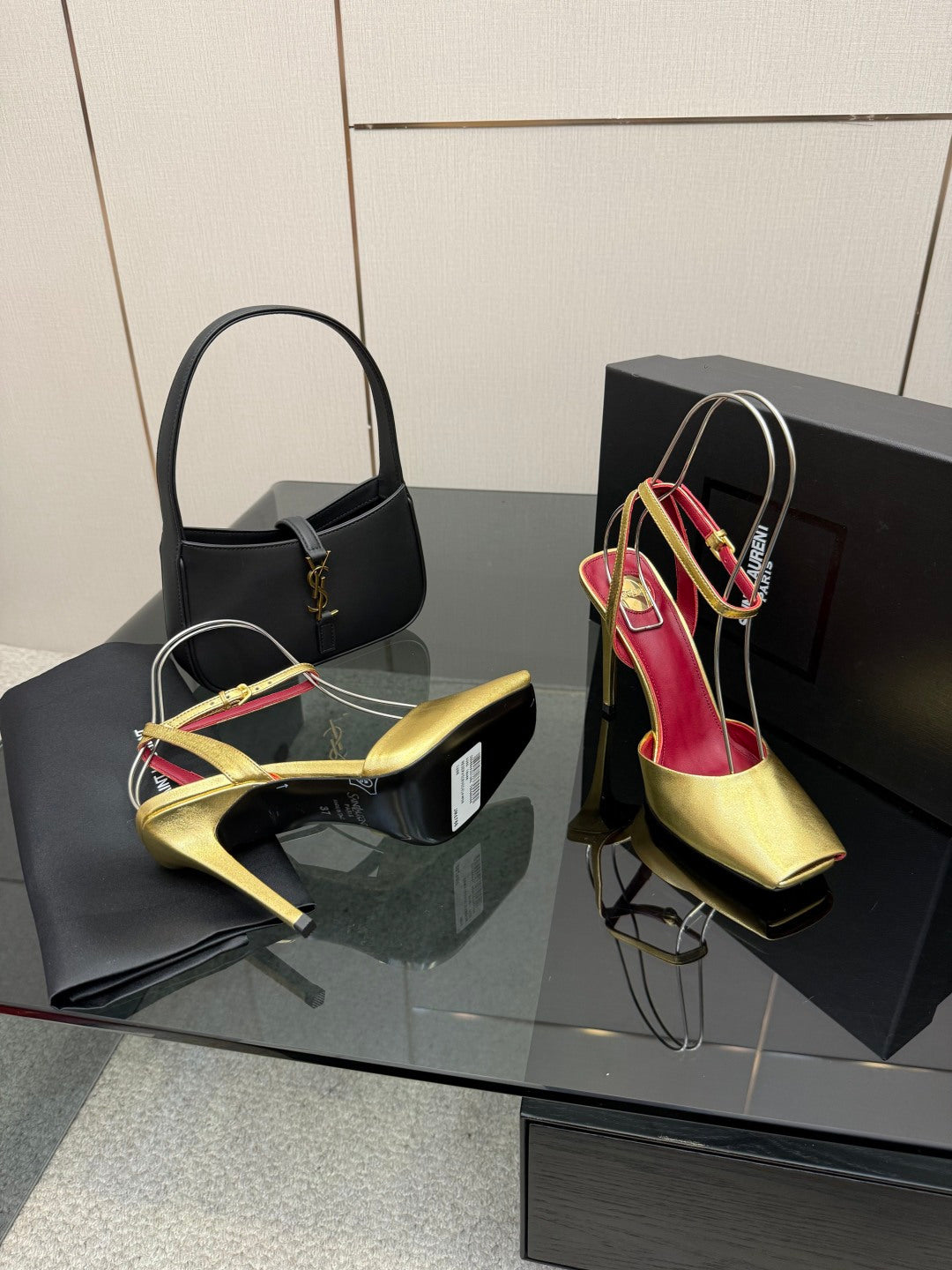 Women’s gold high-heel sandals with red interior and multi-color cord ankle straps