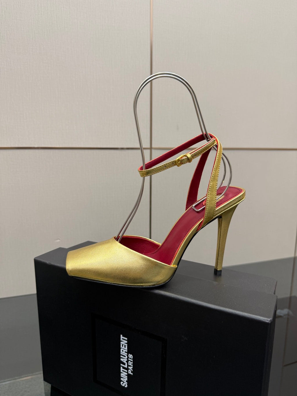 Women’s gold high-heel sandal with red insole and slim ankle strap