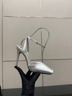 Silver high-heel sandal with thin straps, open toe, and stiletto heel.