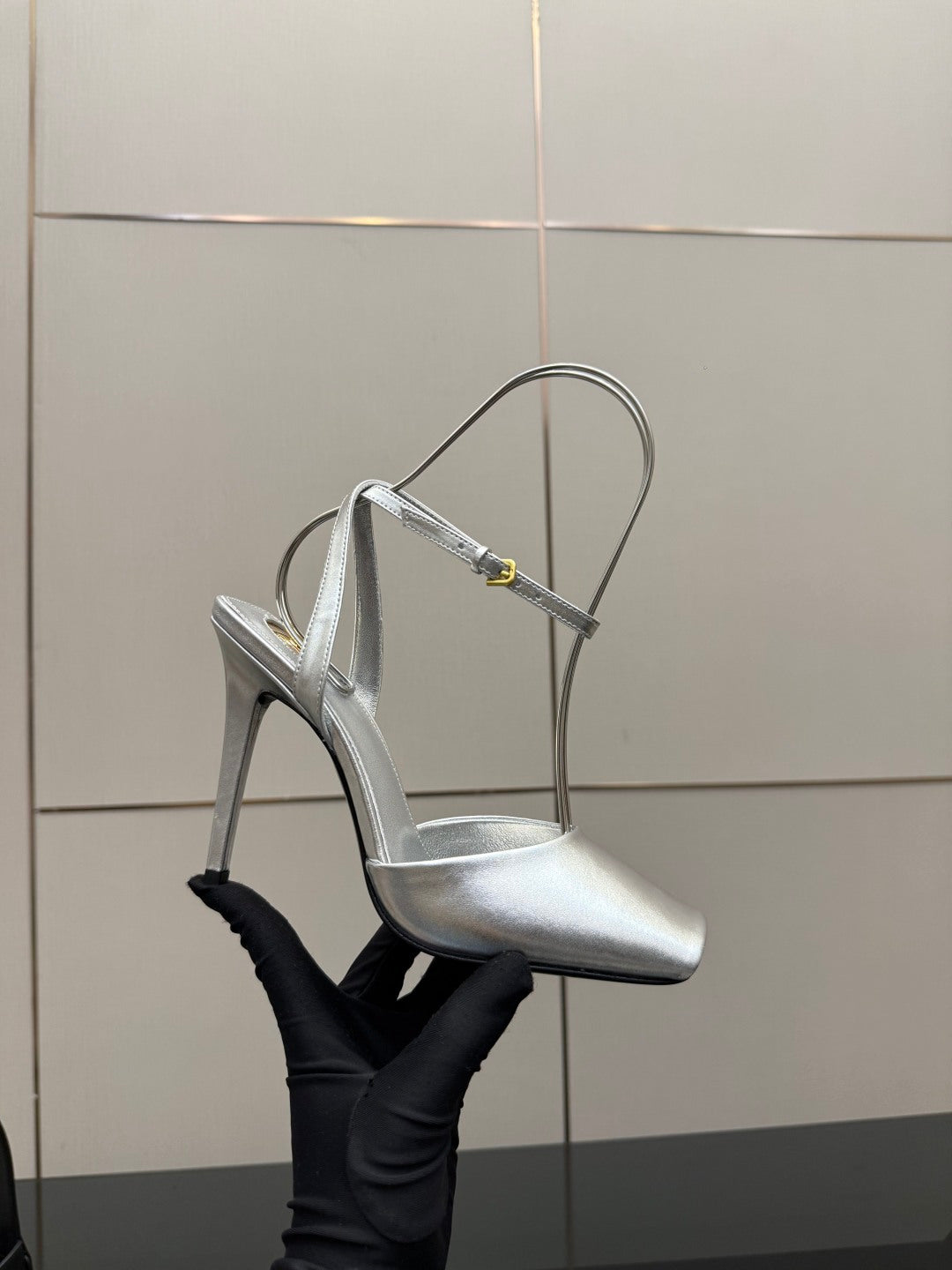 Silver high-heel sandal with thin straps, open toe, and stiletto heel.