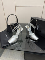 Silver open-toe high-heel sandals with thin ankle straps and slim heel.