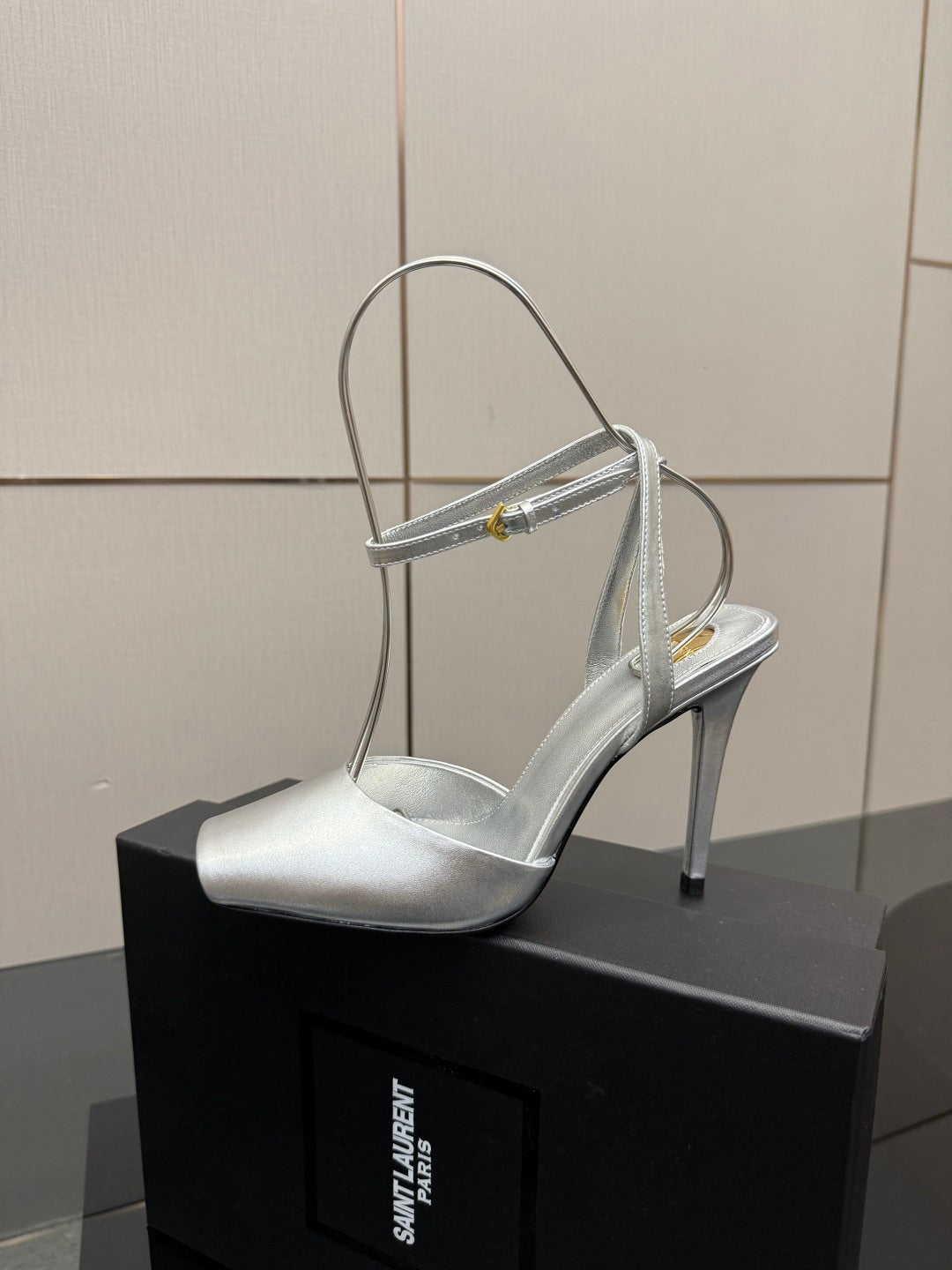 Silver open-toe high-heel sandal with thin ankle-strap and stiletto heel.