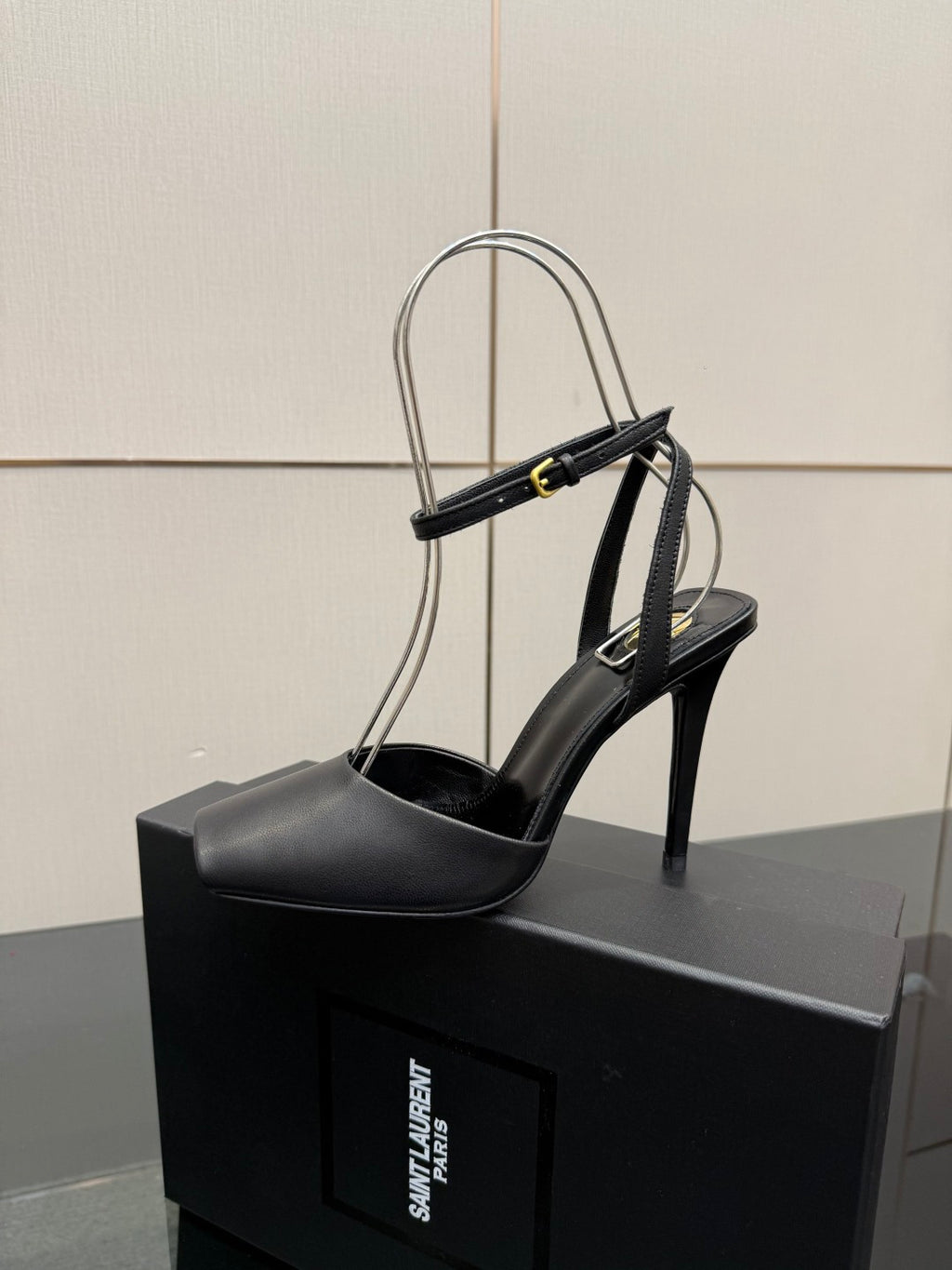YSL black high-heel sandal close-up on single shoe with strappy ankle design