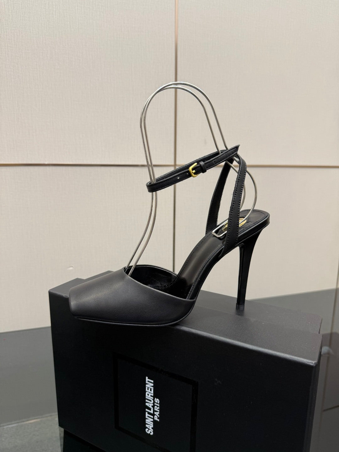 YSL black high-heel sandal close-up on single shoe with strappy ankle design