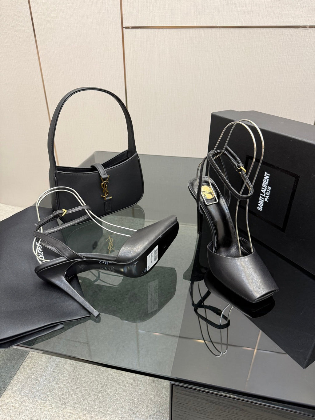 YSL black high-heel sandals angled view with smooth upper and slim stiletto heel