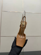 Tan open-toe heeled sandal with thin straps and gold-tone hardware