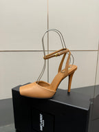 Tan slingback heeled sandal with gold-tone bar across the straps