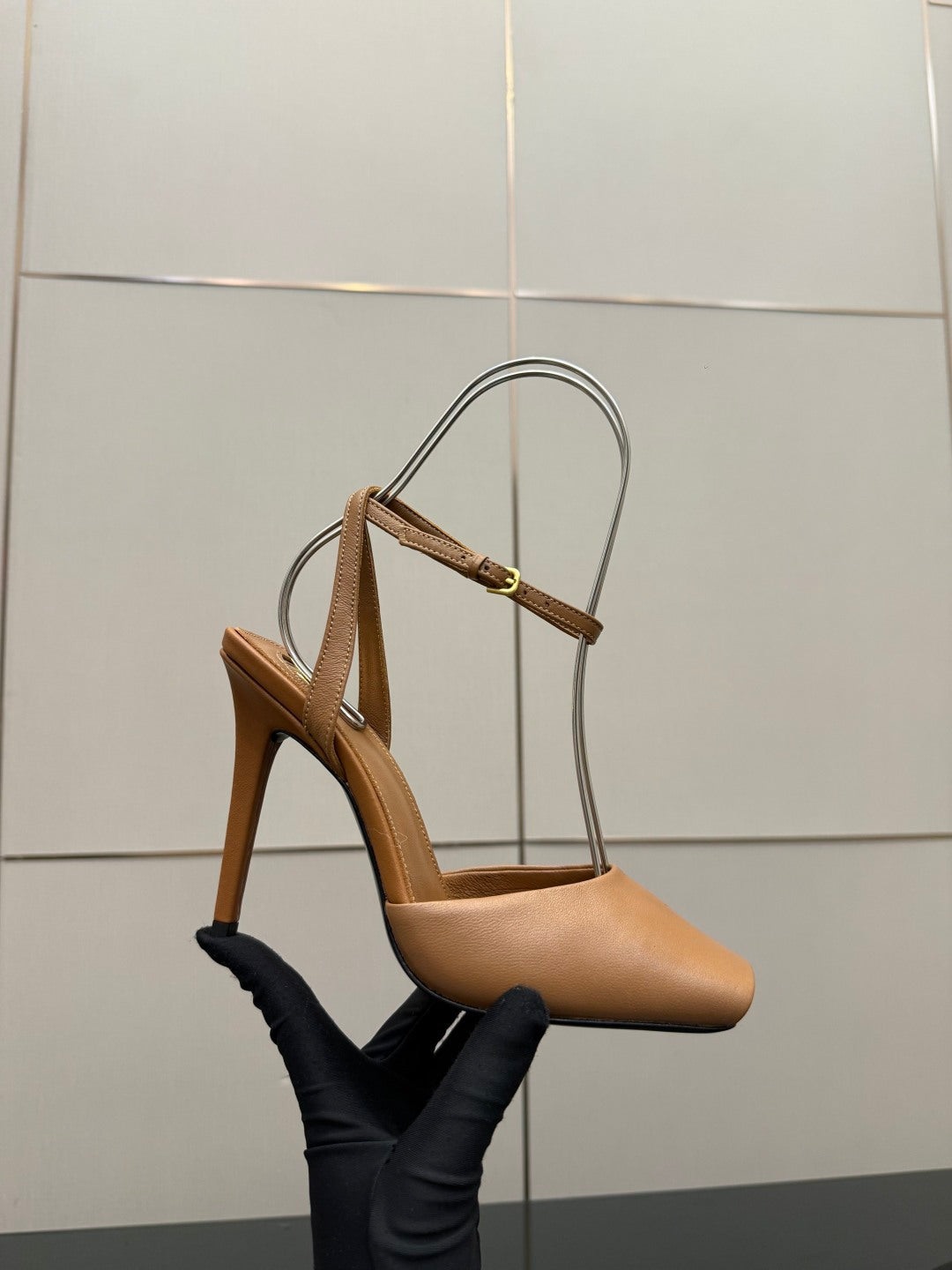Tan heeled sandal with thin straps and gold-tone buckle hardware