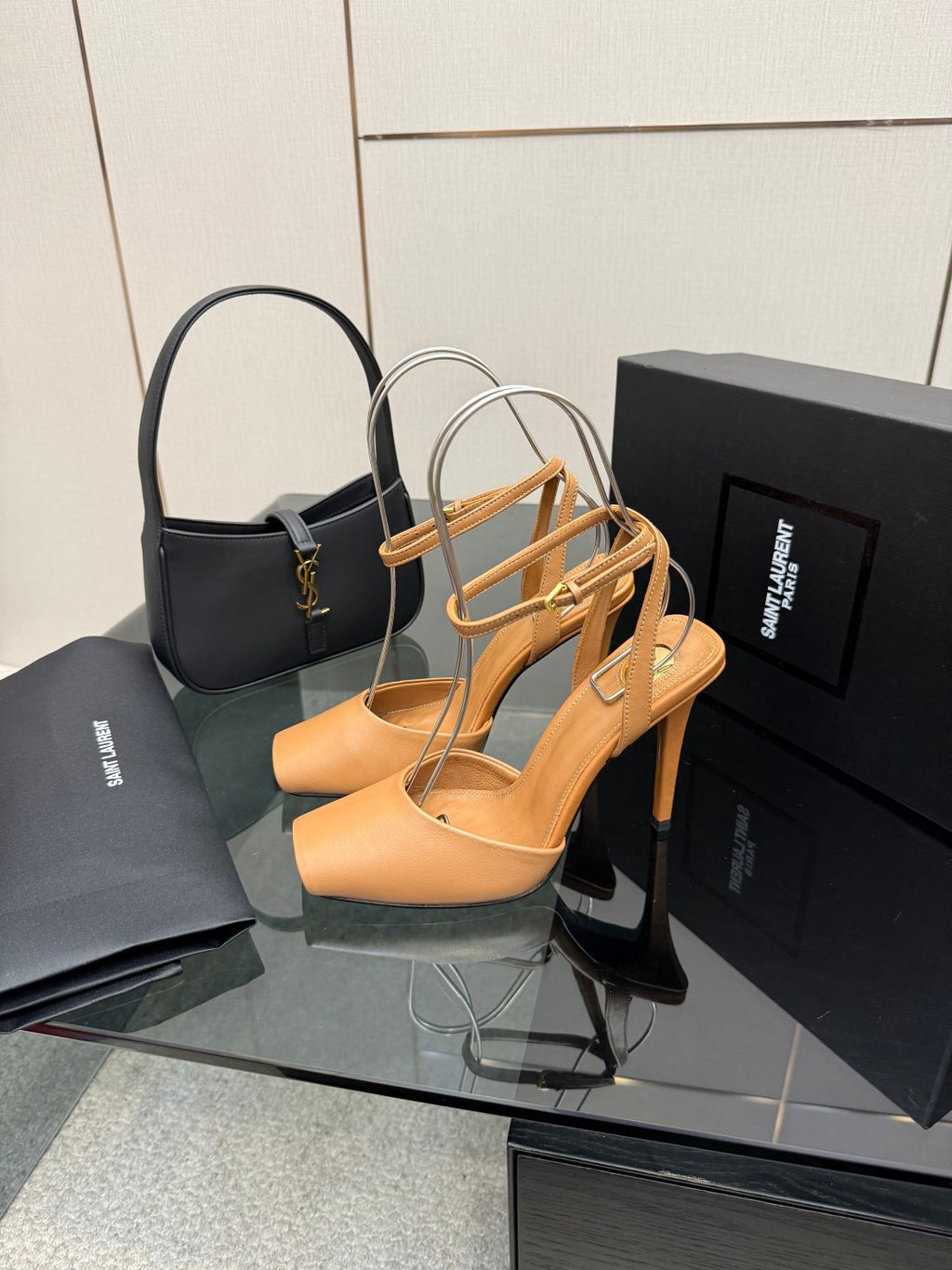 Tan open-toe heeled sandals with thin crisscross straps and gold hardware