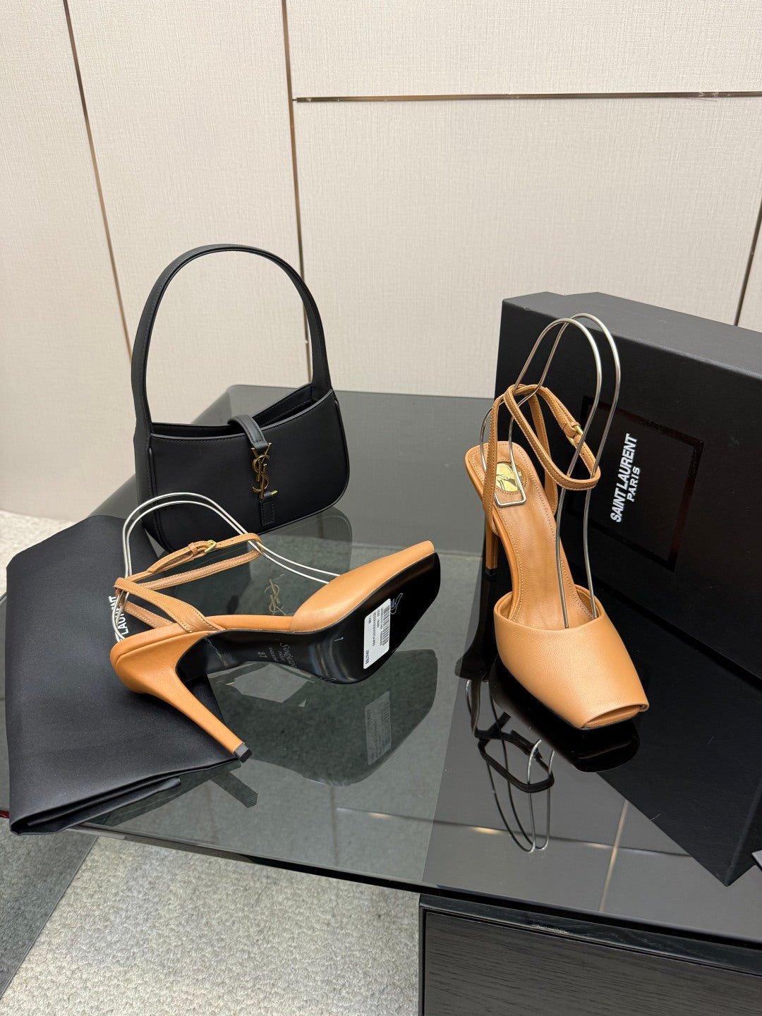 Tan open-toe heeled sandals with thin crisscross straps and gold hardware