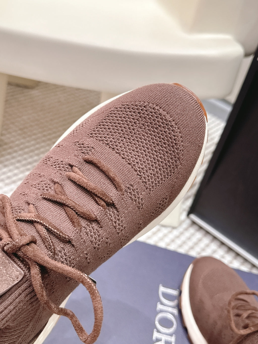 Brown knit upper sneaker detail with lace-up front and white sole