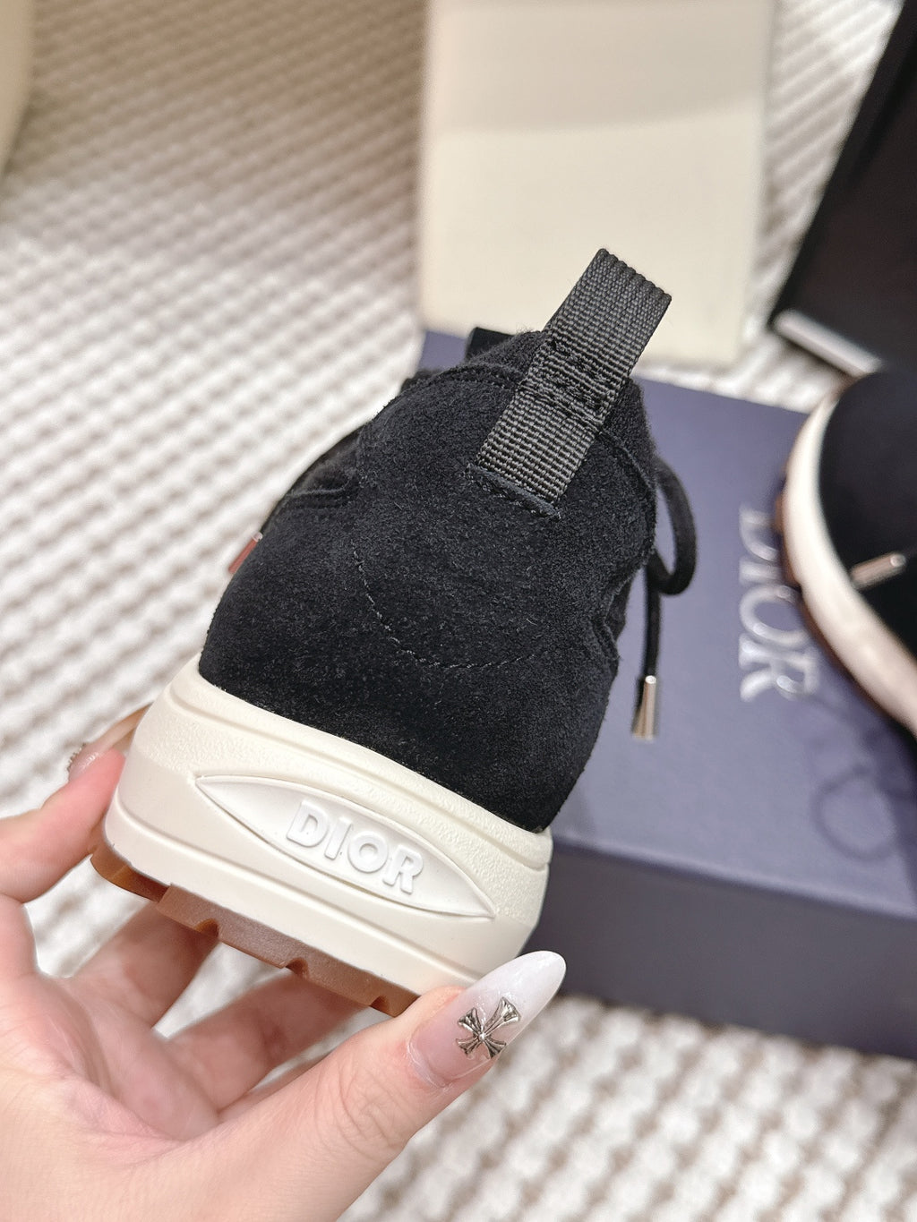 Black Dior unisex sneaker heel with strap pull tab and white midsole