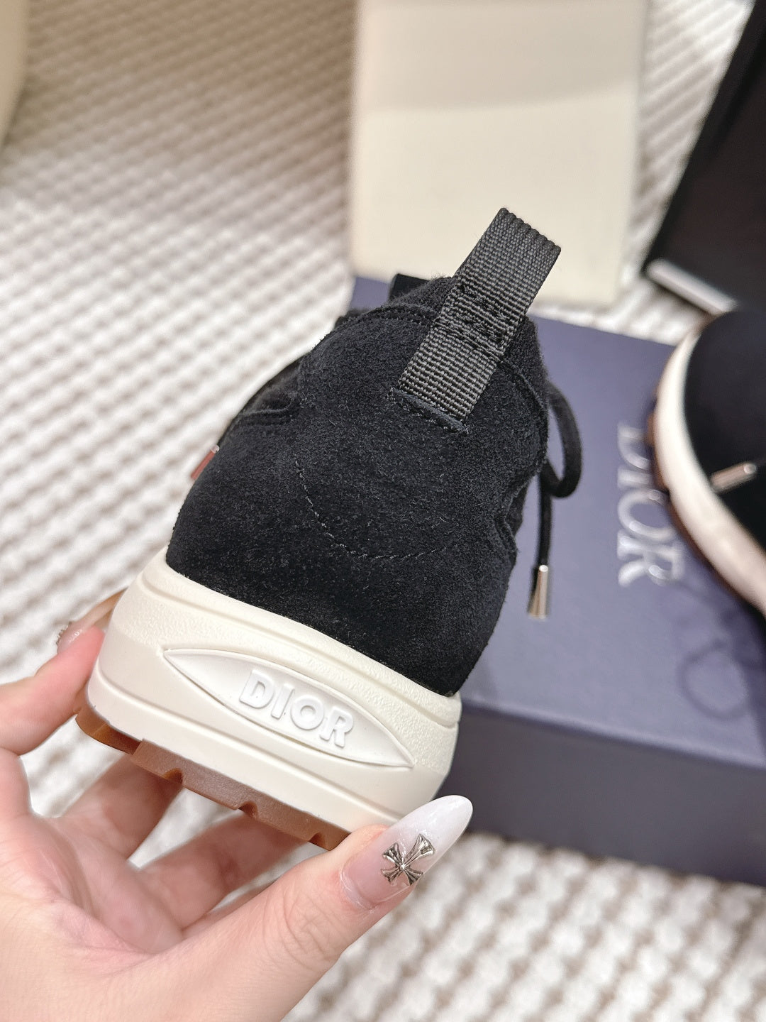 Black Dior unisex sneaker heel with strap pull tab and white midsole