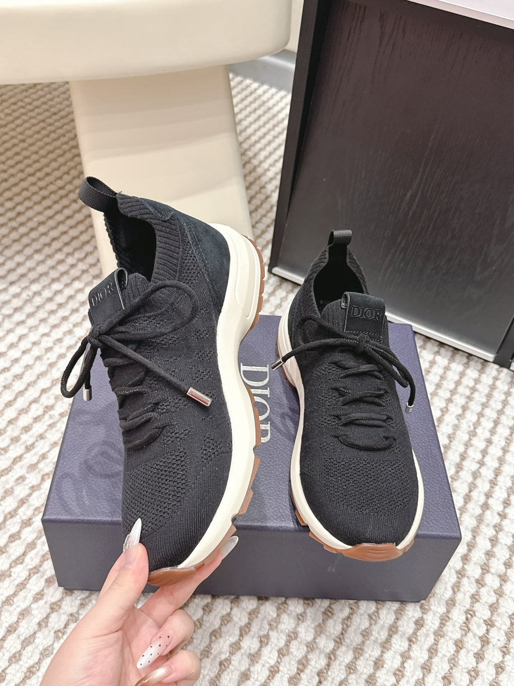 Black Dior unisex sneakers with lace-up front, sock collar, and white sole