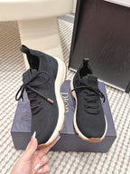 Black Dior unisex sneakers with lace-up front, sock collar, and white sole