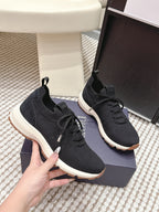 Black Dior unisex sneakers with lace-up front and white outsole edge