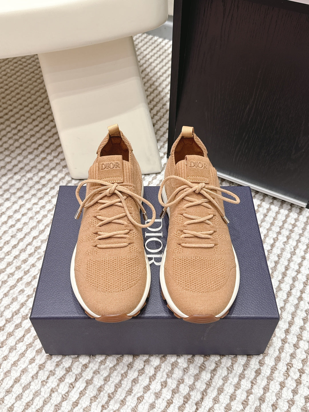 Beige knit Dior sneakers with lace-up front, cushioned soles and logo patch