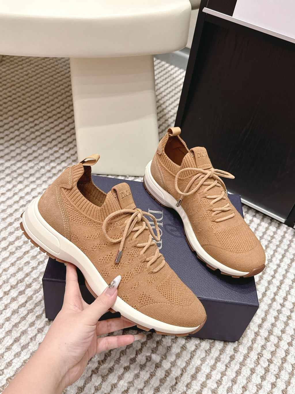 Beige Dior knit sneakers side view, laces and white sole with tread detail