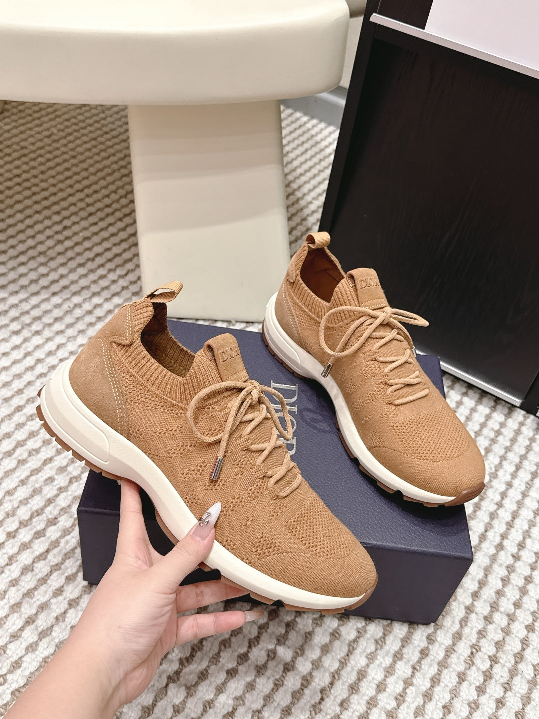 Beige Dior knit sneakers side view, laces and white sole with tread detail