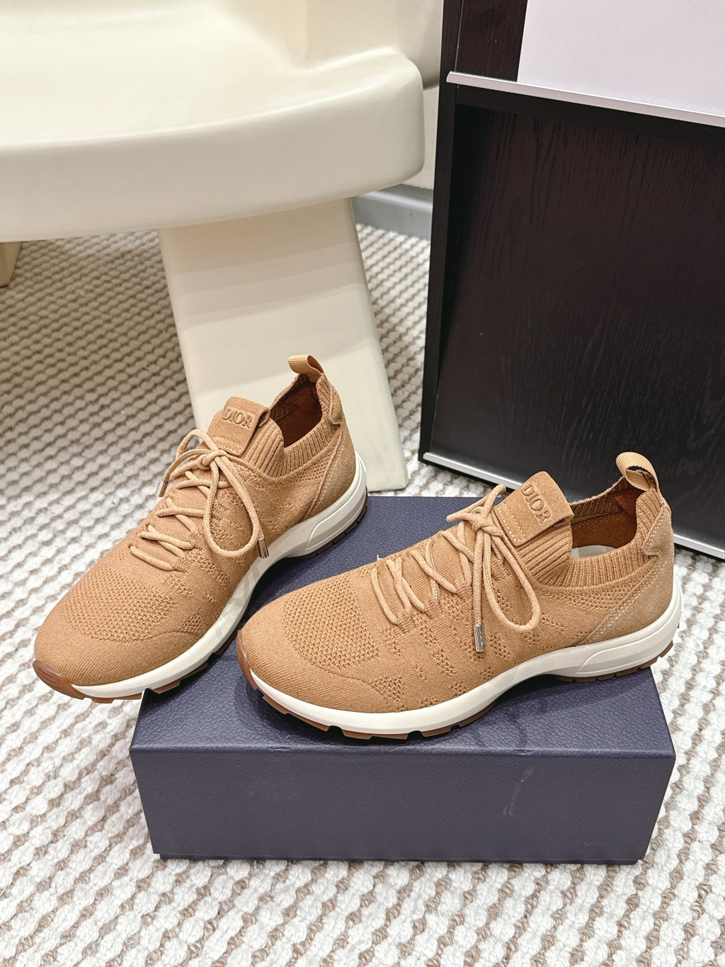 Beige lace-up Dior knit sneakers, side view with white sole and logo tongue