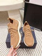 Beige Dior knit sneakers close-up, lace-up with elastic collar and white outsole