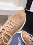 Beige knit Dior sneaker with lace-up and textured fabric upper, front view