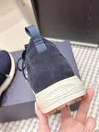 Navy knit sneaker with lace-up, white rubber sole, and Dior heel tab