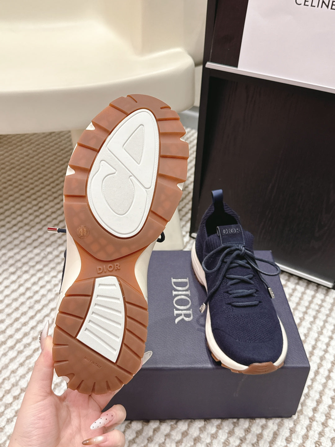 Navy lace-up knit sneakers with treaded white sole and Dior branding on heel