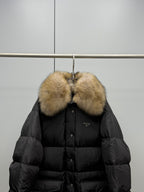 Black puffer jacket front with tan fur collar and triangular logo patch
