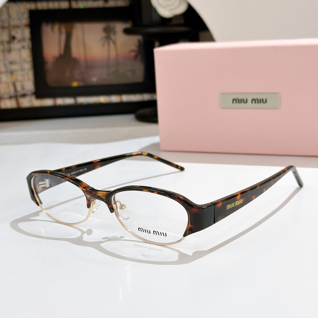 Miu miu eyeglasses with dark tortoiseshell frame and clear lenses, curved rectangular shape