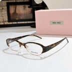 Miu miu eyeglasses with dark tortoiseshell frame and clear lenses, curved rectangular shape