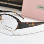 Miu miu eyeglasses close-up: dark front frame with tortoiseshell temple, clear lenses