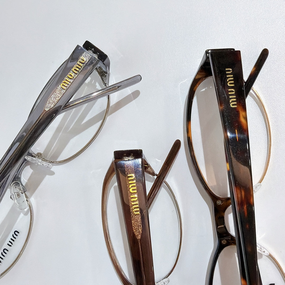 Assorted Miu miu eyeglasses: light silver frame and dark tortoiseshell frame, clear lenses