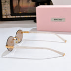 MiuMiu sunglasses with tinted lenses, clear frames and gold temple hinges