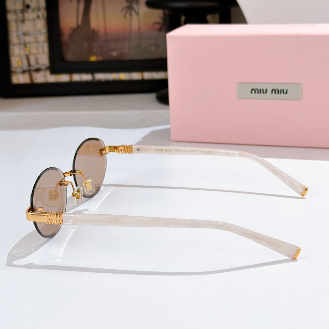 MiuMiu sunglasses with tinted lenses, clear frames and gold temple hinges
