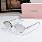 MiuMiu sunglasses with clear frames and light tint lenses, gold temple accents