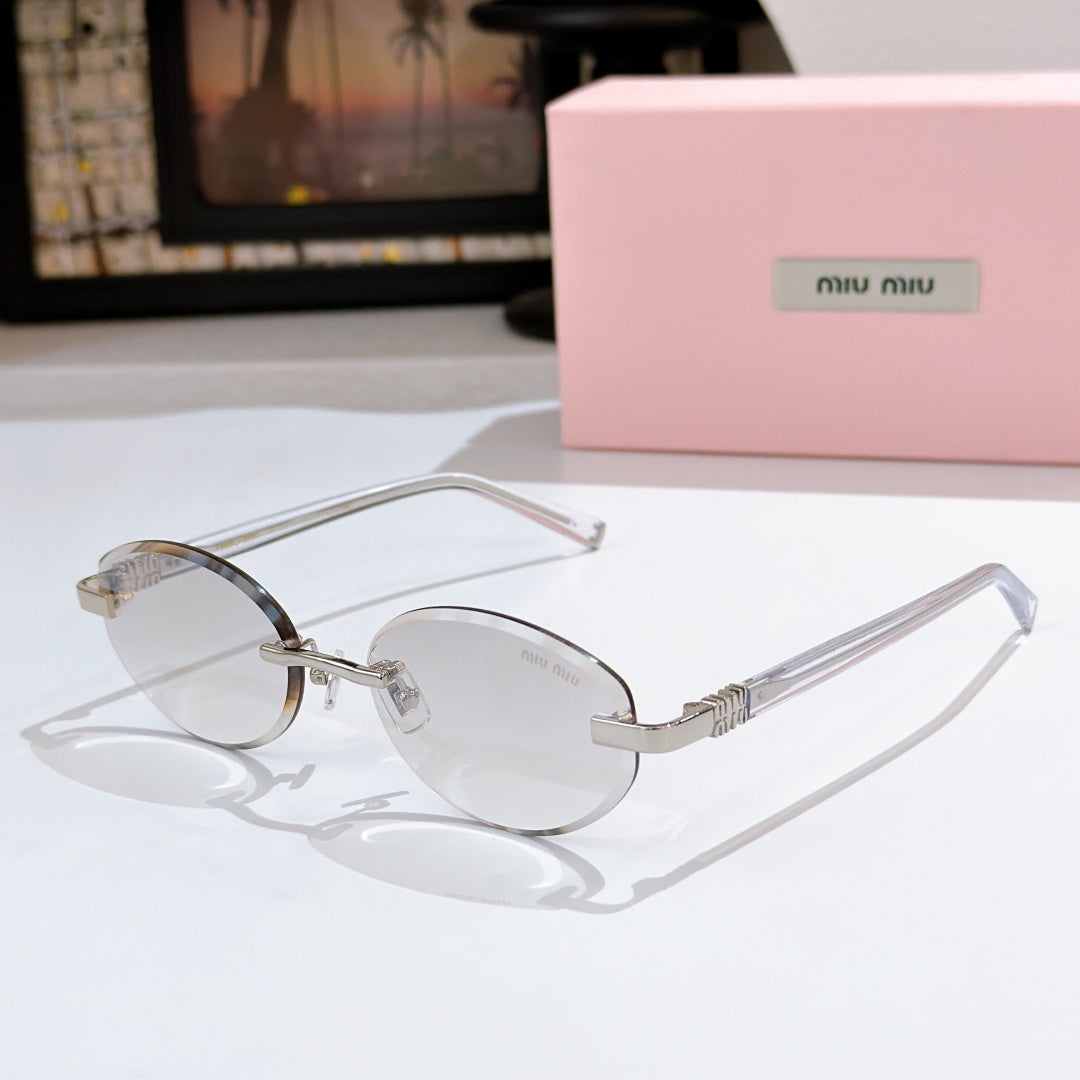 MiuMiu sunglasses with clear frames and light tint lenses, gold temple accents
