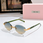 MiuMiu sunglasses with light blue lenses, green frames and gold decorative temples