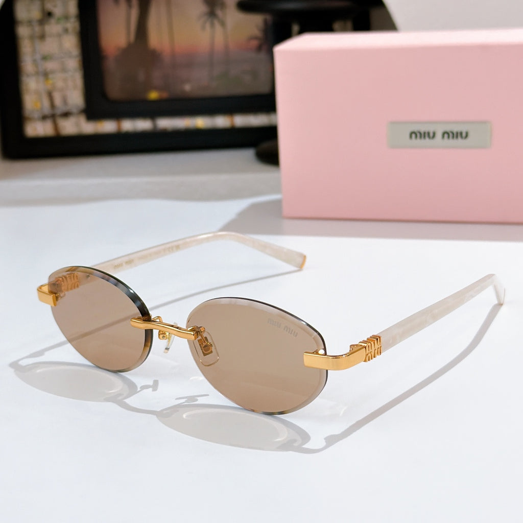 MiuMiu sunglasses with tan lenses, clear frames and gold temple accents