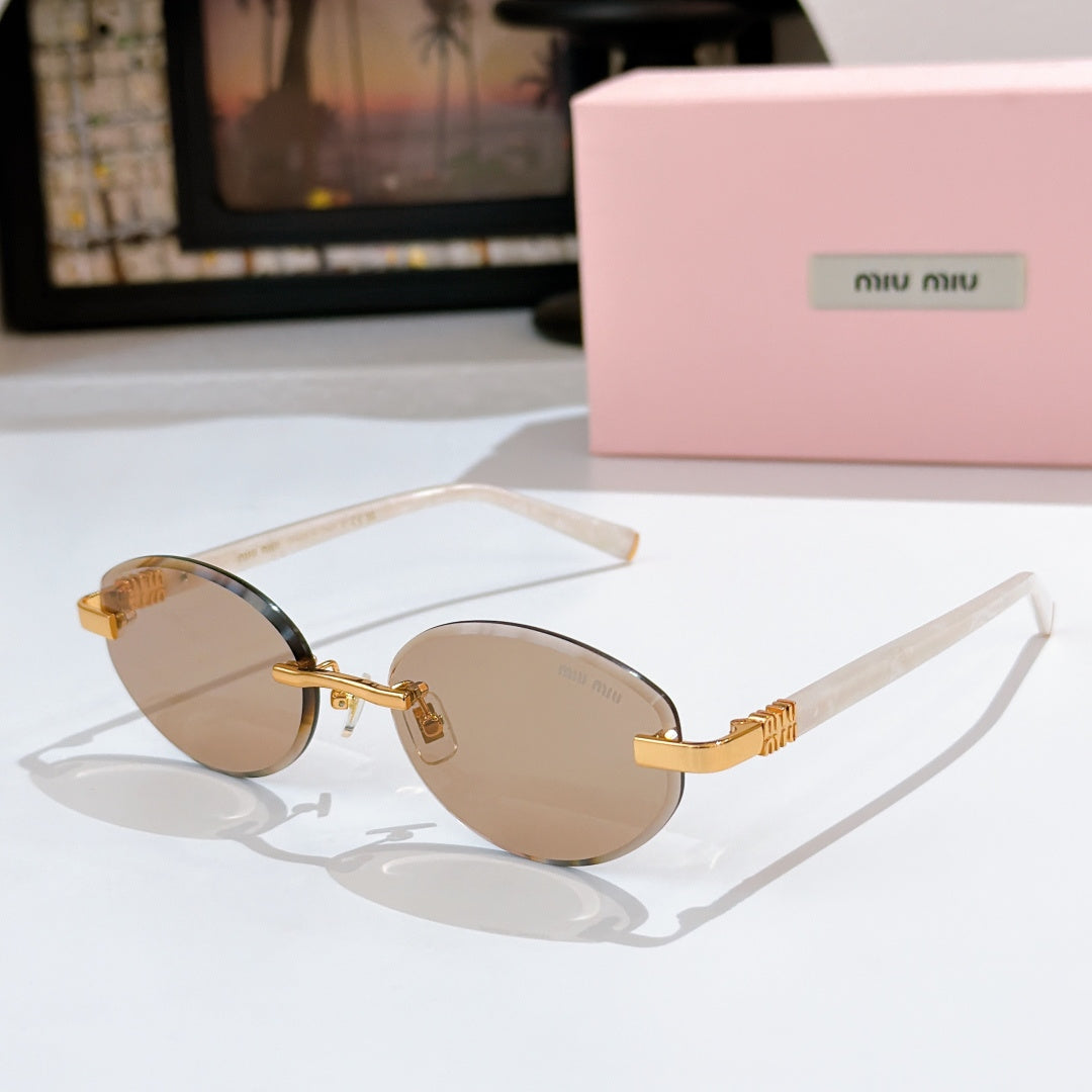 MiuMiu sunglasses with tan lenses, clear frames and gold temple accents