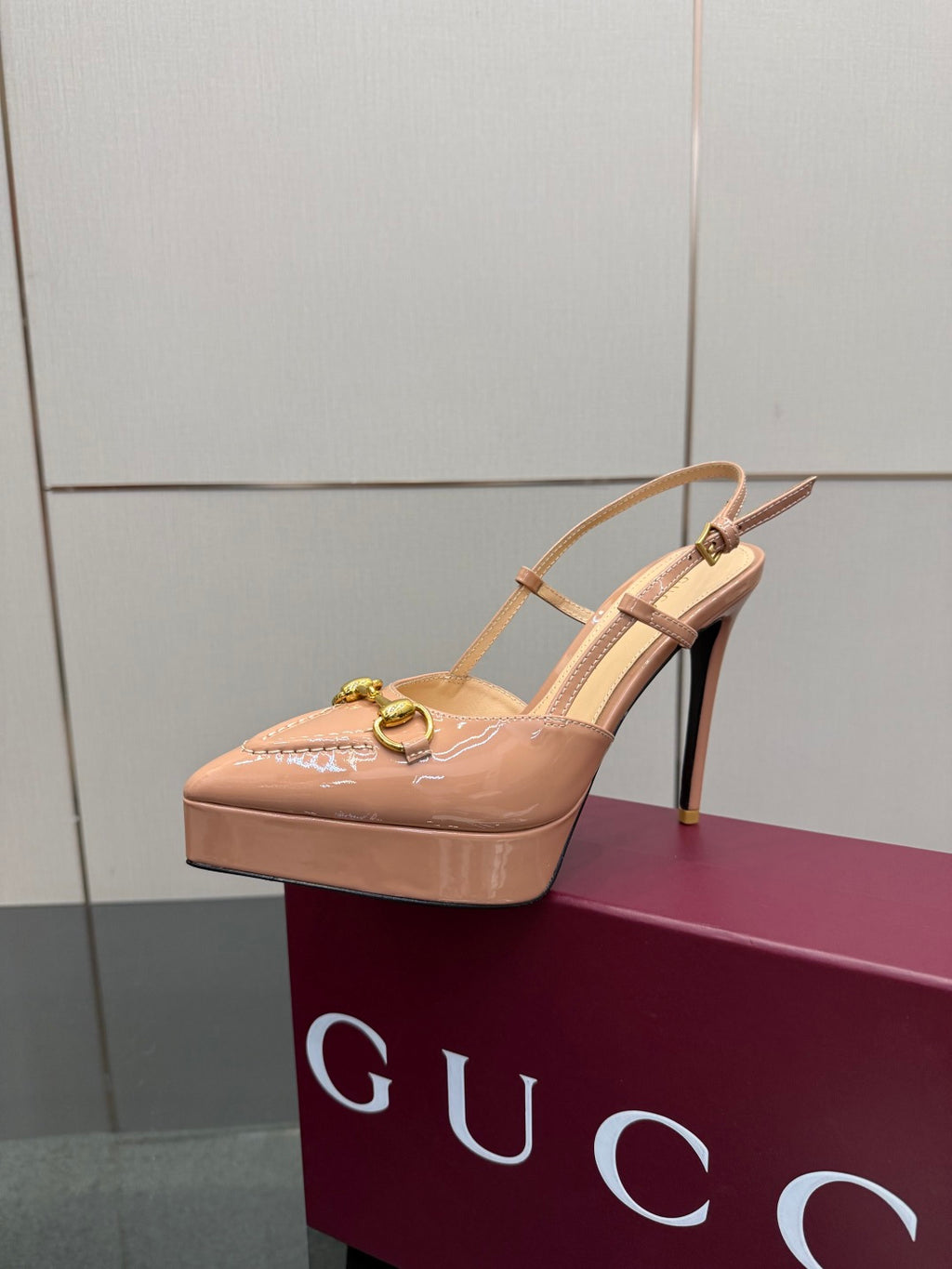 Beige slingback platform pump with gold-tone buckle and stiletto heel, sling strap