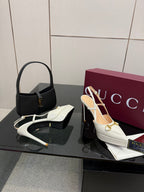 White Gucci slingback heels with gold hardware and slim stiletto heel