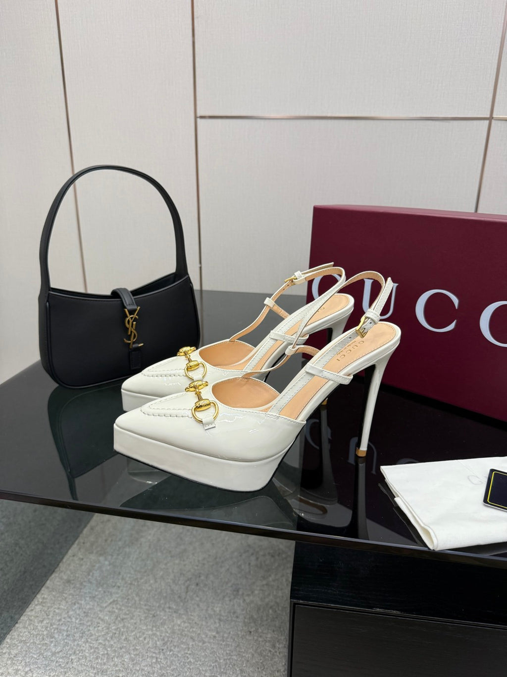 White Gucci slingback heels with gold link hardware and thin heel