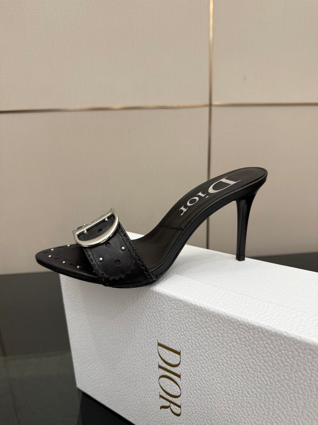 Black studded mule sandal with silver buckle and high stiletto heel