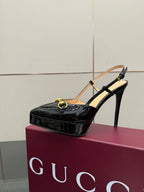 Gucci ladies black patent slingback heel with thin ankle strap and gold chain
