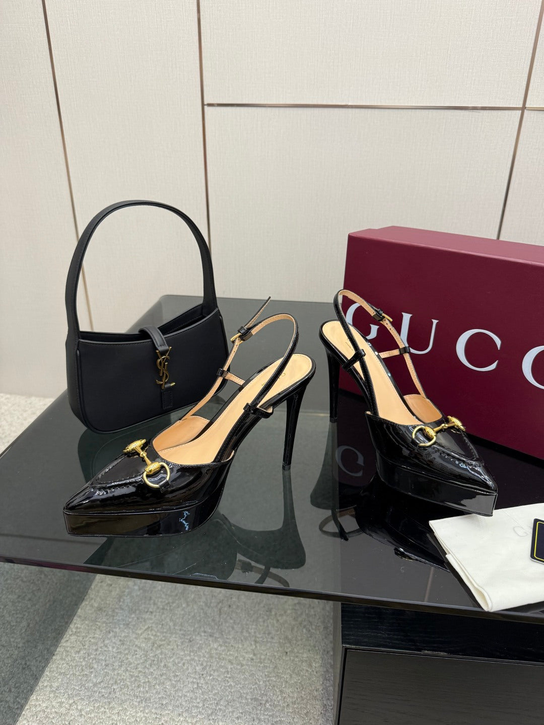 Gucci ladies black slingback heels with gold buckle chain detail, patent finish