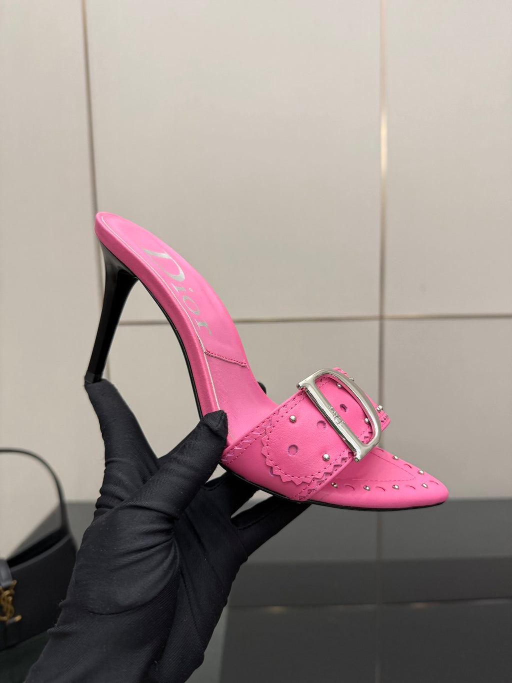 Dior ladies pink mule held in hand, buckle strap and stiletto heel