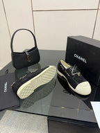 Chanel women’s sneakers with quilted outsole and lace-up dark upper