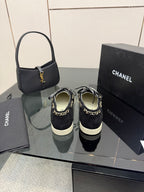 Chanel women’s sneakers with chain detail, shown from the back