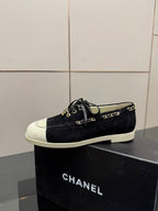Chanel women’s lace-up sneakers, dark fabric with white toe panel and gold chain trim